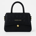 Black quilted handbag with gold hardware and top handle, Bagvalleypk premium collection.