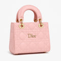 Light pink quilted handbag with gold hardware, Dior logo, luxury designer bag at Bagvalley