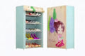 Light blue standing shoe rack with multiple shelves, side features cute girl cartoon design