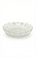 Clear glass decorative plate with scalloped edges on a white background