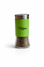 Green pepper shaker with stainless steel lid, filled with black pepper, on white background